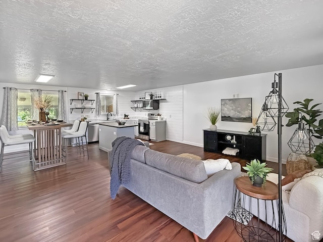 5432 S 800 E, South Ogden, UT 84405 - living area featuring a textured ceiling, baseboards, and dark wood-style floors