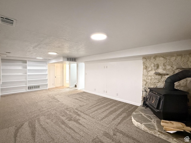 5432 S 800 E, South Ogden, UT 84405 - unfurnished living room with a wood stove, carpet flooring, and baseboards