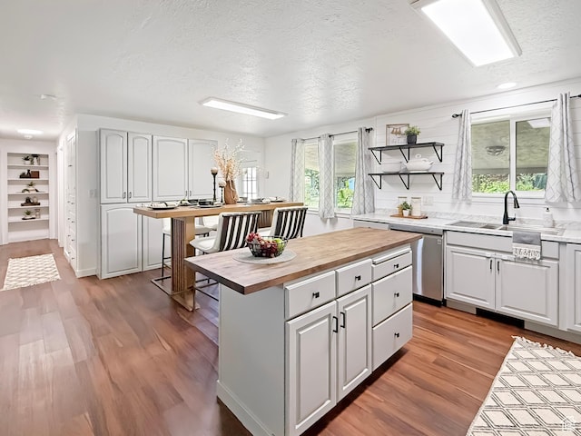 5432 S 800 E, South Ogden, UT 84405 - kitchen featuring dishwasher, wood counters, a sink, a textured ceiling, and wood finished floors