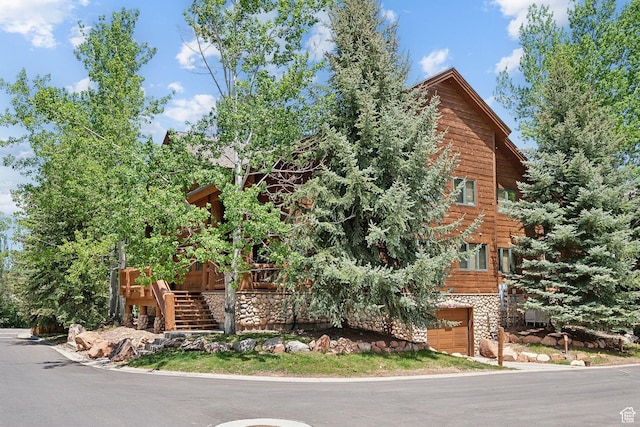 3988 N Timber Wolf Ln Unit 10D, Park City, UT 84098 - view of front facade with an attached garage, stairs, and stone siding