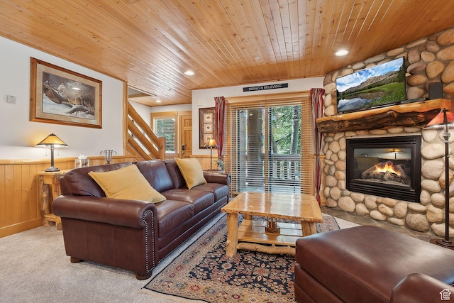 3988 N Timber Wolf Ln Unit 10D, Park City, UT 84098 - living room featuring wood ceiling, a wainscoted wall, a fireplace, stairs, and light colored carpet