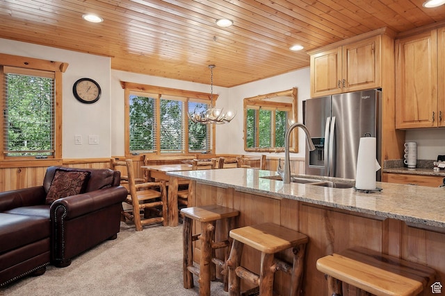 3988 N Timber Wolf Ln Unit 10D, Park City, UT 84098 - kitchen featuring stainless steel fridge, wooden ceiling, a wainscoted wall, recessed lighting, and a breakfast bar