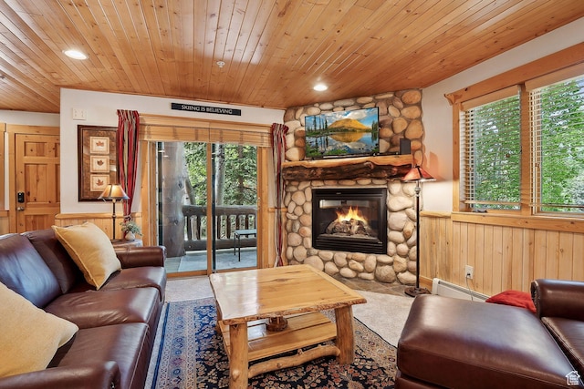 3988 N Timber Wolf Ln Unit 10D, Park City, UT 84098 - living room with a baseboard radiator, a wainscoted wall, plenty of natural light, a stone fireplace, and wood ceiling