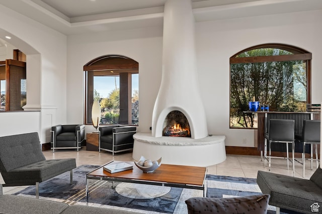 2763 N Chaco Trl, St George, UT 84770 - tiled living room featuring healthy amount of natural light, arched walkways, a large fireplace, and baseboards