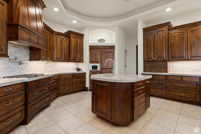 2763 N Chaco Trl, St George, UT 84770 - kitchen with stainless steel gas cooktop, light tile patterned flooring, tasteful backsplash, recessed lighting, and a center island with sink
