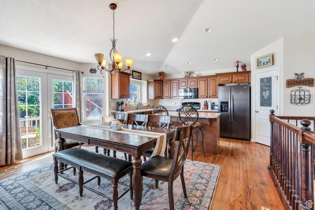 6329 W Basin Ridge Dr, West Valley City, UT 84128 - dining area featuring a chandelier, healthy amount of natural light, lofted ceiling, light wood-style floors, and recessed lighting