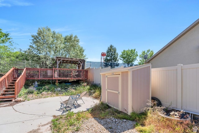6329 W Basin Ridge Dr, West Valley City, UT 84128 - fenced backyard with a patio area, a wooden deck, and stairs