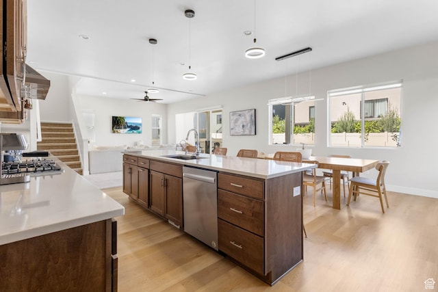 14908 S Fawley Ln, Herriman, UT 84096 - kitchen featuring stainless steel appliances, a sink, light wood-style flooring, an island with sink, and recessed lighting