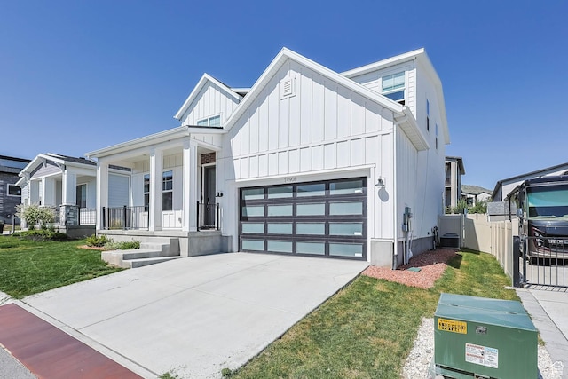 14908 S Fawley Ln, Herriman, UT 84096 - modern inspired farmhouse featuring board and batten siding, a garage, covered porch, and concrete driveway