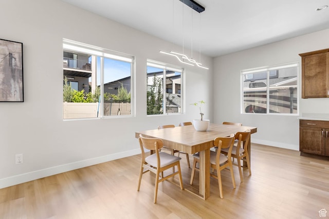 14908 S Fawley Ln, Herriman, UT 84096 - dining space with light wood-style floors and baseboards
