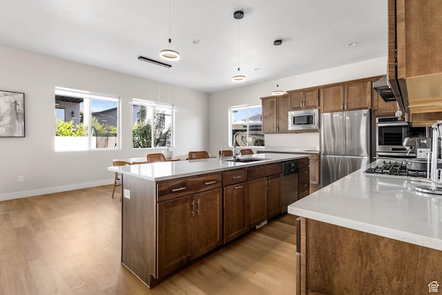 14908 S Fawley Ln, Herriman, UT 84096 - kitchen featuring stainless steel appliances, a sink, light wood finished floors, and light countertops