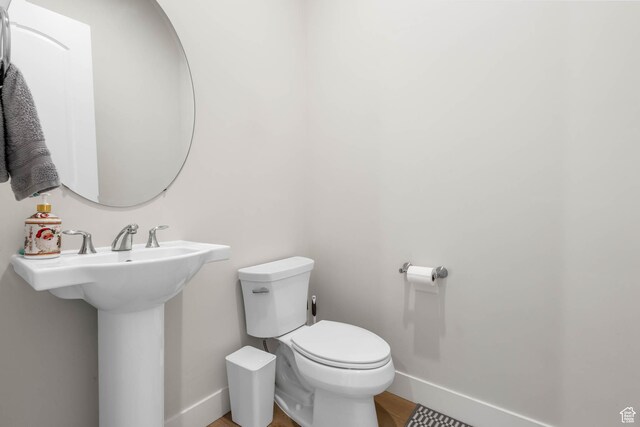 14908 S Fawley Ln, Herriman, UT 84096 - half bath with toilet, baseboards, wood finished floors, and a sink