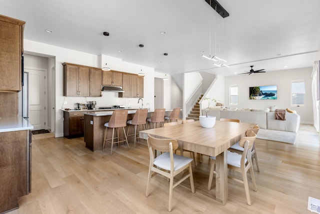 14908 S Fawley Ln, Herriman, UT 84096 - dining area with stairs, light wood-style flooring, and a ceiling fan