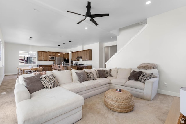 14908 S Fawley Ln, Herriman, UT 84096 - living room featuring ceiling fan, recessed lighting, baseboards, light colored carpet, and stairway