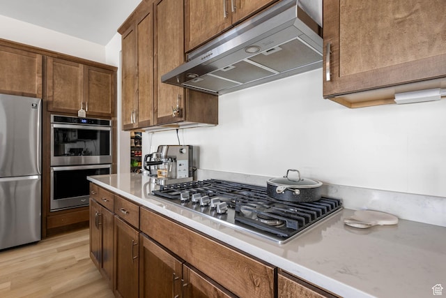14908 S Fawley Ln, Herriman, UT 84096 - kitchen featuring stainless steel appliances, under cabinet range hood, and light wood-style floors