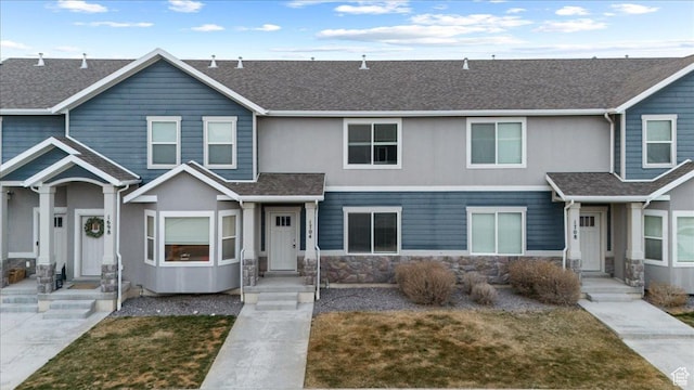1704 E Talon Way, Eagle Mountain, UT 84005 - townhome / multi-family property with roof with shingles, stone siding, and a front lawn