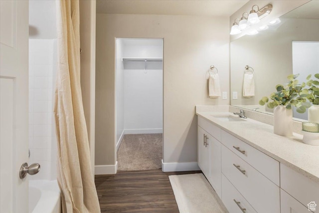 1704 E Talon Way, Eagle Mountain, UT 84005 - bathroom with vanity, wood finished floors, shower / bathtub combination with curtain, and baseboards