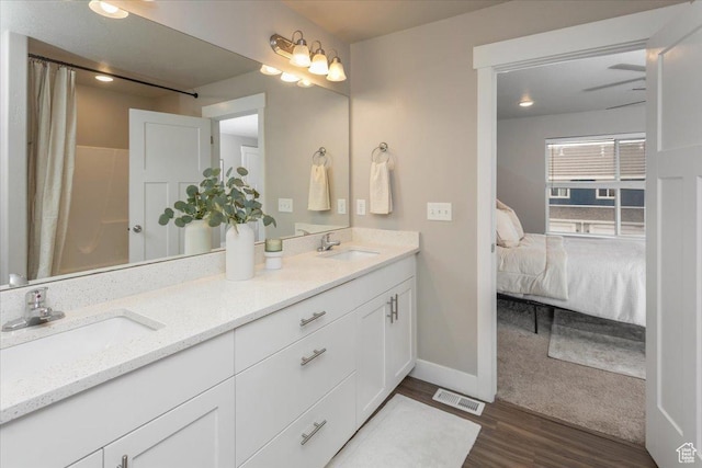 1704 E Talon Way, Eagle Mountain, UT 84005 - ensuite bathroom with double vanity, wood finished floors, baseboards, and a shower with curtain