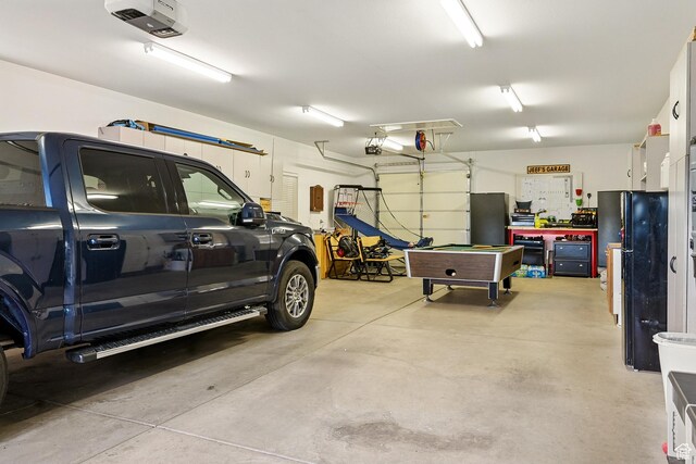 2271 W Crestview Cir, Cedar City, UT 84720 - garage with freestanding refrigerator and a garage door opener