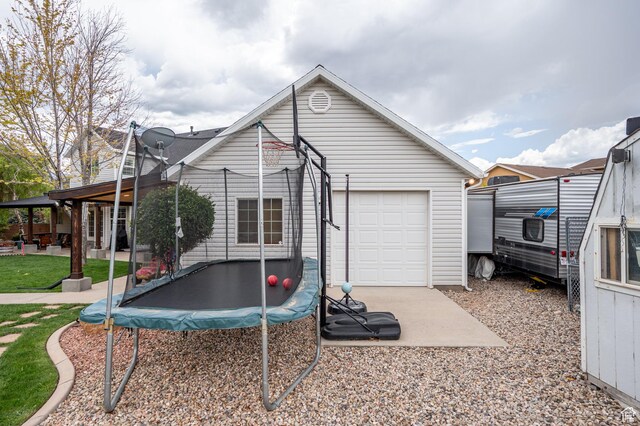 2271 W Crestview Cir, Cedar City, UT 84720 - back of house featuring a trampoline, a garage, and a patio