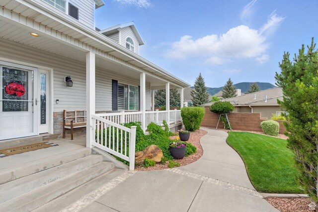 2271 W Crestview Cir, Cedar City, UT 84720 - doorway to property with covered porch, a mountain view, and a yard