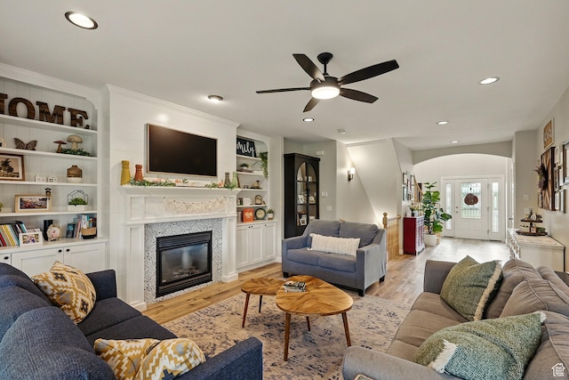2271 W Crestview Cir, Cedar City, UT 84720 - living room with arched walkways, a ceiling fan, light wood-style floors, recessed lighting, and a glass covered fireplace