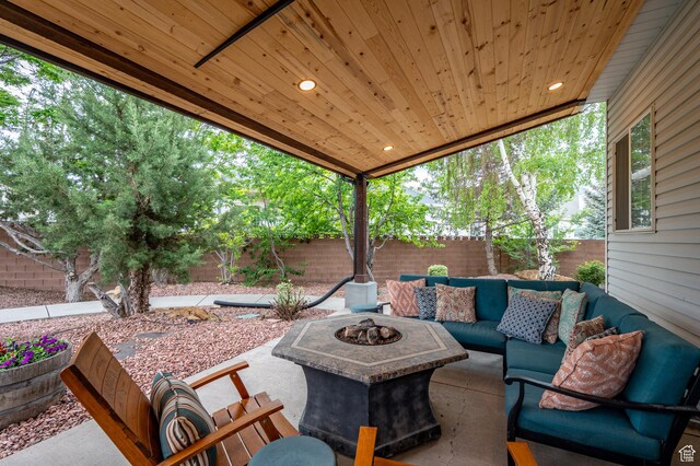 2271 W Crestview Cir, Cedar City, UT 84720 - fenced backyard with an outdoor living space with a fire pit and a patio area