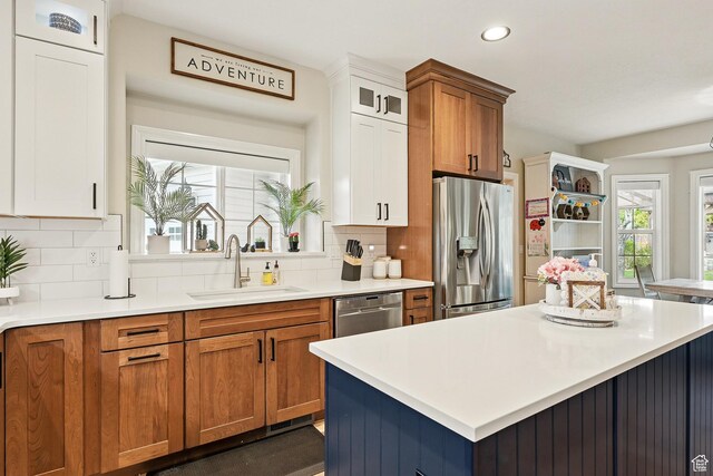 2271 W Crestview Cir, Cedar City, UT 84720 - kitchen featuring appliances with stainless steel finishes, a sink, brown cabinetry, light countertops, and recessed lighting