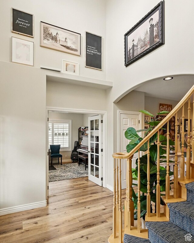 2271 W Crestview Cir, Cedar City, UT 84720 - foyer entrance featuring wood finished floors, baseboards, stairway, a high ceiling, and arched walkways