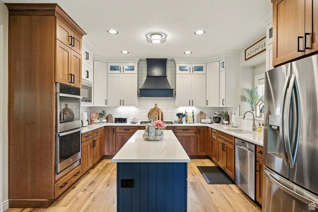 2271 W Crestview Cir, Cedar City, UT 84720 - kitchen featuring appliances with stainless steel finishes, custom range hood, a sink, decorative backsplash, and a kitchen island