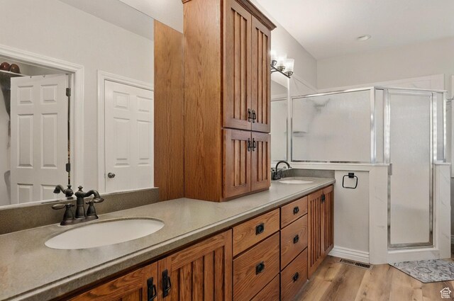 2271 W Crestview Cir, Cedar City, UT 84720 - full bathroom featuring a shower stall, double vanity, and wood finished floors