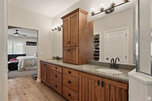 2271 W Crestview Cir, Cedar City, UT 84720 - bathroom with double vanity, ceiling fan, wood finished floors, and connected bathroom
