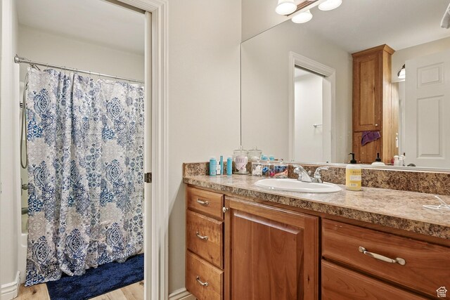 2271 W Crestview Cir, Cedar City, UT 84720 - full bathroom with vanity, wood finished floors, and shower / bath combo