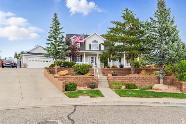 2271 W Crestview Cir, Cedar City, UT 84720 - view of front of home with stairs, concrete driveway, an attached garage, and a porch