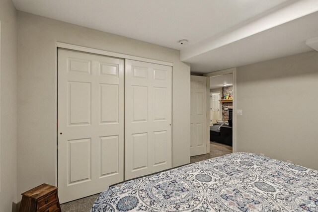 2271 W Crestview Cir, Cedar City, UT 84720 - bedroom featuring carpet flooring, a stone fireplace, and a closet