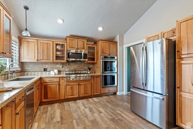 4456 N 3800 W, Peterson, UT 84050 - kitchen featuring stainless steel appliances, a sink, lofted ceiling, decorative backsplash, and a textured ceiling