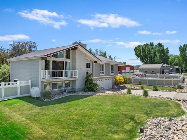 4456 N 3800 W, Peterson, UT 84050 - rear view of property featuring a garage, a chimney, metal roof, and driveway