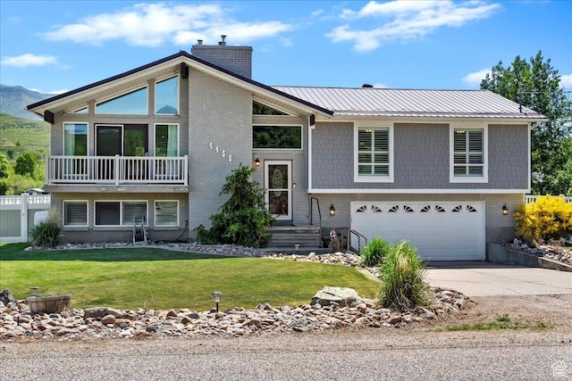 4456 N 3800 W, Peterson, UT 84050 - view of front of property featuring a garage, a chimney, concrete driveway, a front yard, and metal roof