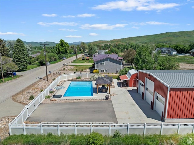 4456 N 3800 W, Peterson, UT 84050 - view of pool with a mountain view, a fenced backyard, and an outbuilding