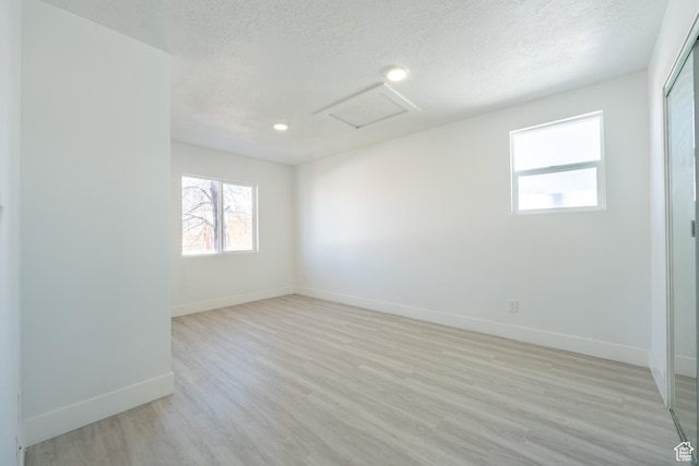 2202 S Lake St, South Salt Lake, UT 84106 - empty room with attic access, a textured ceiling, baseboards, light wood-style floors, and recessed lighting