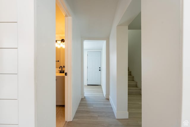 2202 S Lake St, South Salt Lake, UT 84106 - hall featuring light wood-type flooring, baseboards, and stairway