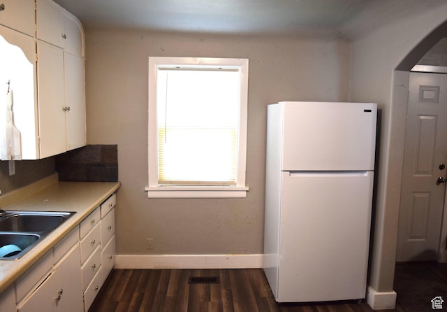 540 S 200 W, Logan, UT 84321 - kitchen featuring freestanding refrigerator, a sink, arched walkways, white cabinetry, and baseboards