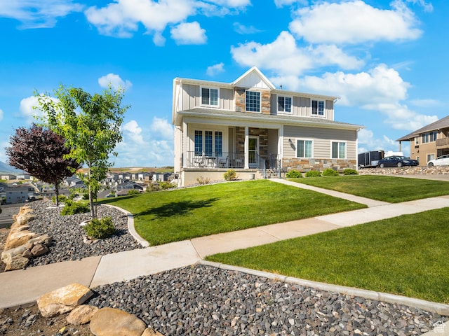 1353 Sageberry Dr, Santaquin, UT 84655 - view of front of property with stone siding, board and batten siding, covered porch, and a front lawn