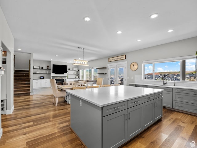 1353 Sageberry Dr, Santaquin, UT 84655 - kitchen with gray cabinets, light countertops, a center island, recessed lighting, and light wood-style floors