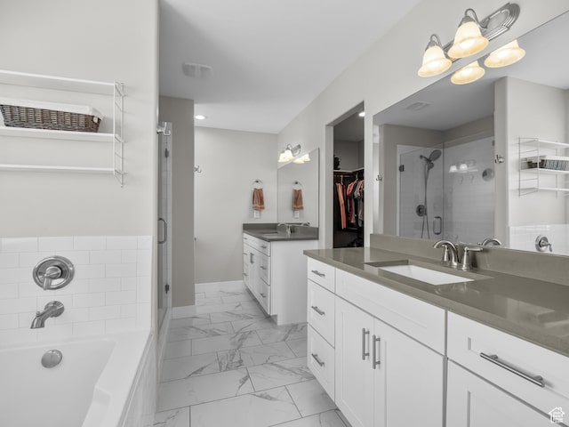 1353 Sageberry Dr, Santaquin, UT 84655 - full bathroom featuring a stall shower, marble look tile flooring, two vanities, and a bath