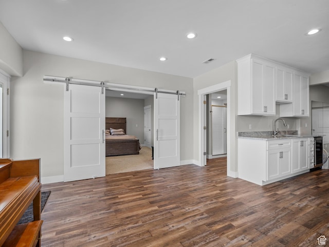 1353 Sageberry Dr, Santaquin, UT 84655 - kitchen featuring a barn door, dark wood-style floors, white cabinetry, wine cooler, and recessed lighting