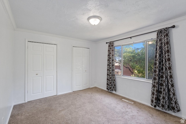 399 E 400 N Unit 2A, Bountiful, UT 84010 - unfurnished bedroom with multiple closets, carpet, and ornamental molding