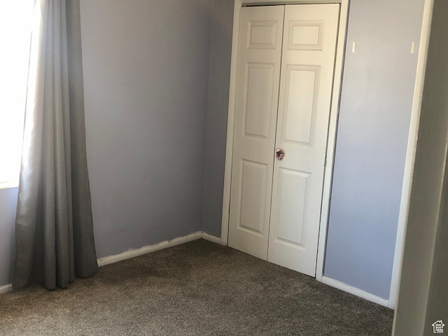 399 E 400 N Unit 2A, Bountiful, UT 84010 - unfurnished bedroom featuring dark colored carpet, baseboards, and a closet