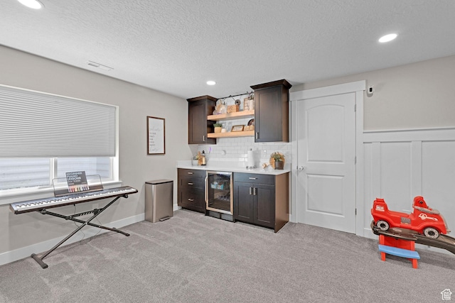 12473 S Desert Mesa Dr, Herriman, UT 84096 - indoor wet bar featuring wine cooler, light colored carpet, recessed lighting, decorative backsplash, and a textured ceiling
