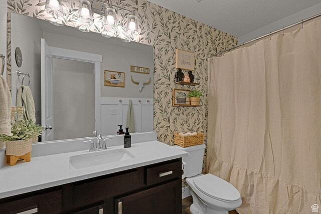 12473 S Desert Mesa Dr, Herriman, UT 84096 - full bathroom featuring wallpapered walls, vanity, toilet, and curtained shower